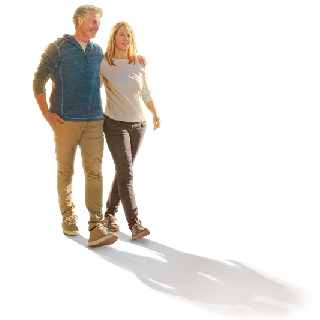 Man and woman walking with their arms around each other.